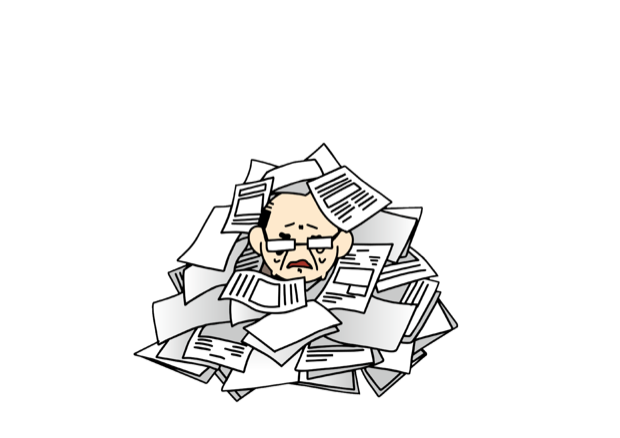 机に積み上がった書類に埋もれる人